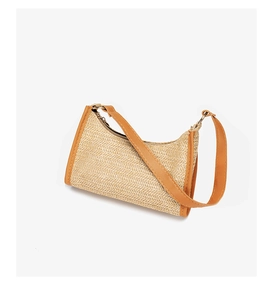 Close-up of the fine woven straw texture and premium brown leather trim on the bag