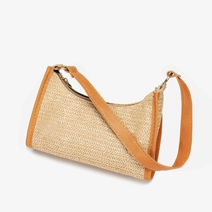 Fashionable woven hobo underarm bag with caramel leather trim and minimalist straw texture