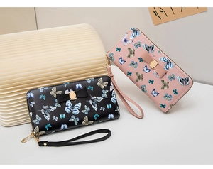 Portefeuille long à motif papillon rose et noir avec nœud décoratif et dragonne