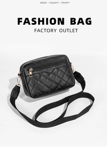 Detail of black quilted shoulder bag with golden zipper and adjustable nylon strap