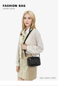 Close-up of a black quilted leather crossbody bag featuring elegant gold zipper hardware