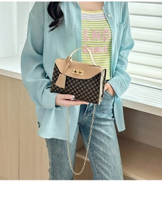 Detail of small crossbody bag with coffee print pattern and gold metal twist lock