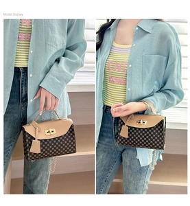 Detail of printed crossbody square bag with gold twist lock and metal chain strap