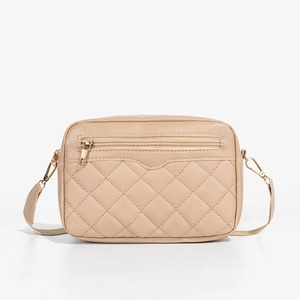 Classic beige quilted crossbody bag with gold hardware and front zipper pocket on white background