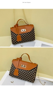 Detail view of the vintage brown geometric pattern handbag with golden chain and clasp