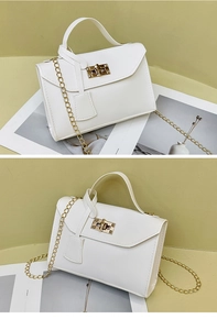 Detailed view of white lychee pattern PU leather handbag with golden chain and lock