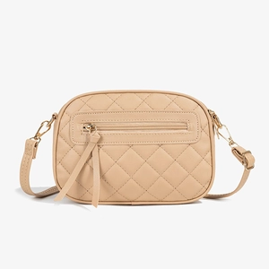 Beige quilted camera bag with triple zippers, gold hardware, and long leather tassels