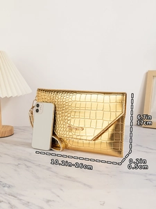 Detail view of gold crocodile pattern envelope clutch showing dimensions in centimeters and inches