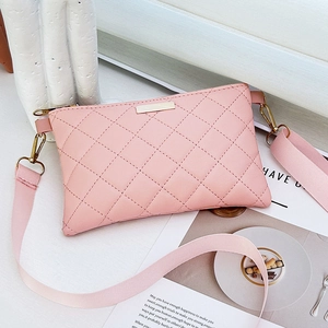 Chic pink quilted crossbody bag with gold hardware and stylish wide woven strap