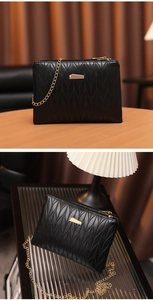 Detail view of black PU leather shoulder bag with quilted diamond texture and gold chain