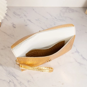 Golden crocodile embossed wristlet clutch bag with metal ring and white interior lining