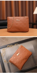 Detailed close-up of brown heart-quilted crossbody bag with elegant gold chain strap
