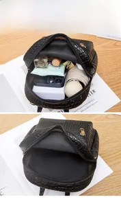 Detail view of crocodile pattern mini backpack showing large interior storage space