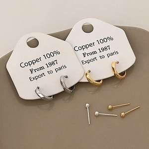 Close-up of a 6-piece copper earring set including twist hoops and ball studs in gold and silver