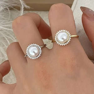 Elegant pearl rings with zircon halo in gold and silver finish on model finger