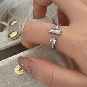 Close-up of silver zircon ring showing rectangular detail and micro-pave setting on hand