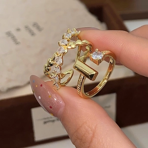 Macro shot of gold-plated rings with micro-pave cubic zirconia and twisted band detail
