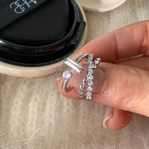 Macro detail of silver heart ring with stacked T-bars and micro-set cubic zirconia stones