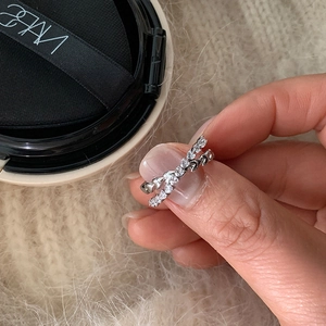 Close-up of double-layer silver heart ring featuring micro-pave cubic zirconia accents