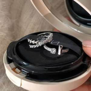 Detailed view of silver micro-set zircon rings with textured band and T-shaped design