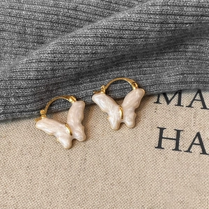 French vintage butterfly earrings with gold hooks and pearlescent white enamel texture