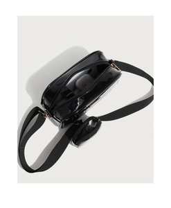 Top view of glossy PU leather bag interior with mini coin purse and wide strap detail