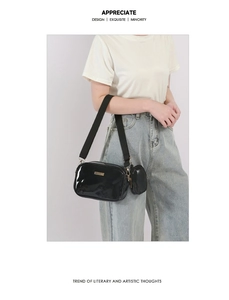 Glossy black PU leather crossbody bag with wide strap and detachable coin purse detail