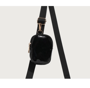 Detail of glossy black mini pouch with gold zipper and adjustable nylon strap