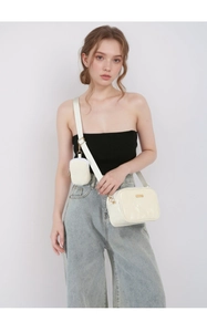 Beige patent leather crossbody bag with wide strap and matching mini coin purse detail
