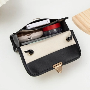 Fashionable woven contrast crossbody bag with gold buckle showing internal storage space