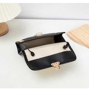 Close-up of contrast woven square bag with golden twist lock and thin shoulder strap