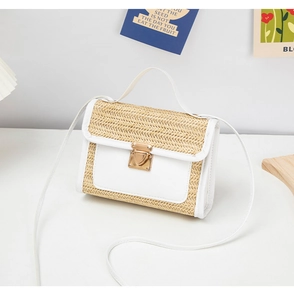 Detail of woven straw mini bag with white leather trim and gold metal clasp closure