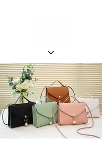 Chic embossed crossbody bags in five colors with pearl charms on a stylish table