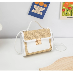 Detailed view of woven straw and white faux leather patchwork bag with gold metal clasp