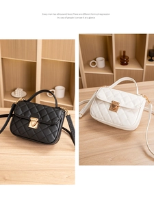 Quilted crossbody bags in black and white with gold locks on a wooden desk