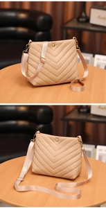 Detail of beige PU leather crossbody bag with V-quilted stitching and gold-tone hardware