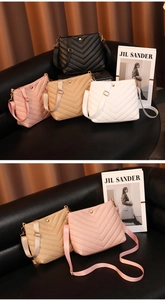 Detail of four multi-colored PU leather bucket bags with V-shaped quilted stitching