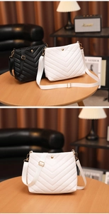 Detail of V-quilted faux leather bucket bags in black and white with adjustable straps
