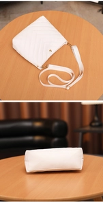 Detailed view of white PU leather bucket bag with V-shaped chevron quilting and gold hardware
