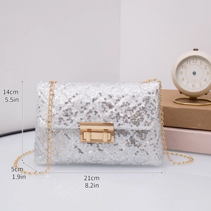 Close-up of silver sequin evening bag with gold rectangular clasp and chain strap
