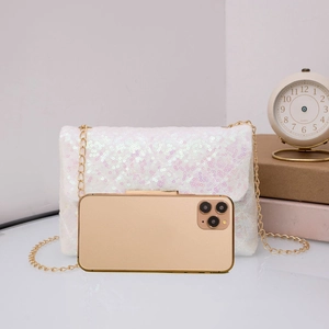 Detailed scale view of a white sequin crossbody bag next to a smartphone