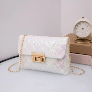 Close-up of iridescent sequins on a white crossbody bag with a golden chain strap