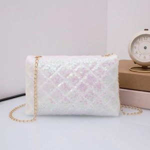 Close-up of white sequin crossbody bag with quilted pattern and gold chain strap