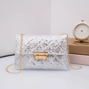 Close-up of sparkling silver sequins and golden chain strap on a chic evening crossbody bag