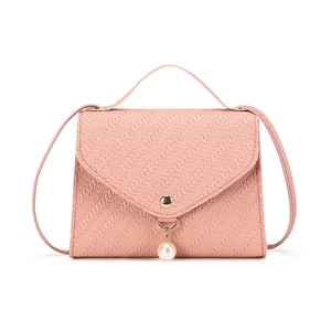 Minimalist light pink crossbody bag with woven texture and elegant pearl pendant accessory