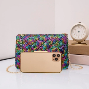 Close-up of rainbow sequin crossbody bag with gold chain and phone for size reference