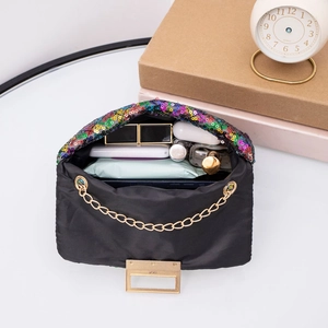 Internal view of black nylon chain bag showing daily storage capacity for essentials