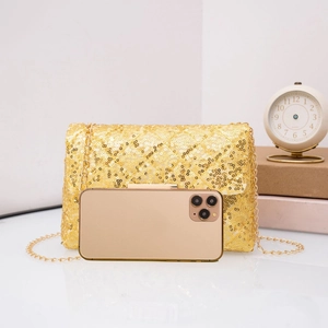 Detail of sequined crossbody bag with golden chain showing size comparison to a phone