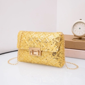 Detail of gold sequin chain bag featuring a rectangular metal twist lock and metallic texture