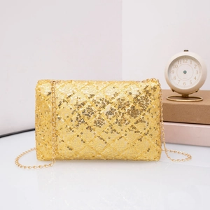 Detail of elegant gold sequin clutch bag with metal chain strap on a stylish background